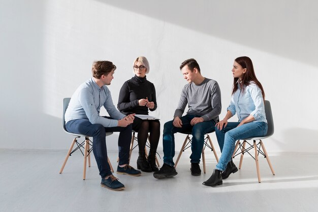 Rehab patients sitting in a  white room