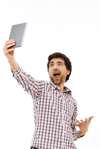 Rejoicing man raising tablet up, found wifi