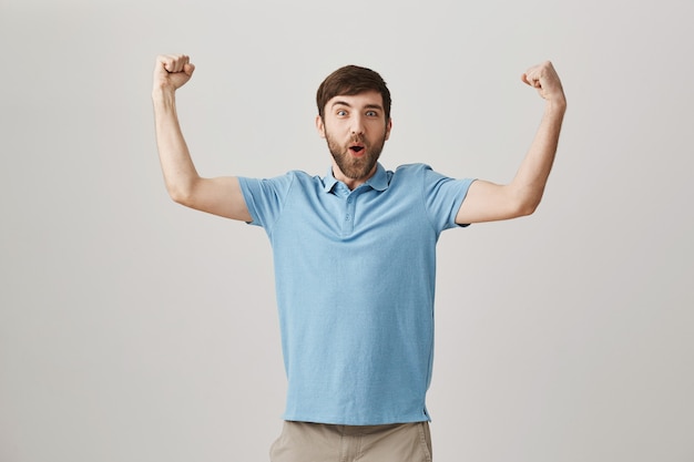 Rejoicing young bearded man posing