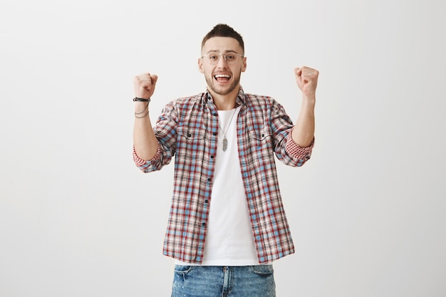 Rejoicing young guy posing