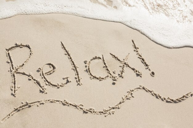 Relax written on sand