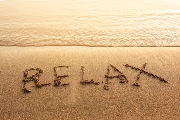 Relax written on sand