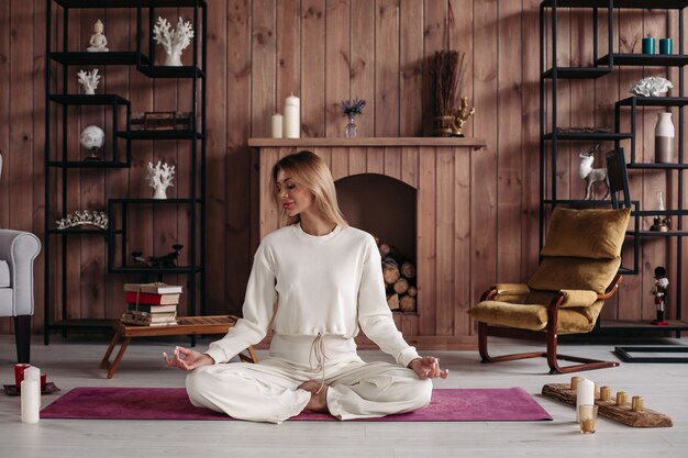 Relaxed beautiful woman with fair hair is going to meditate in the morning