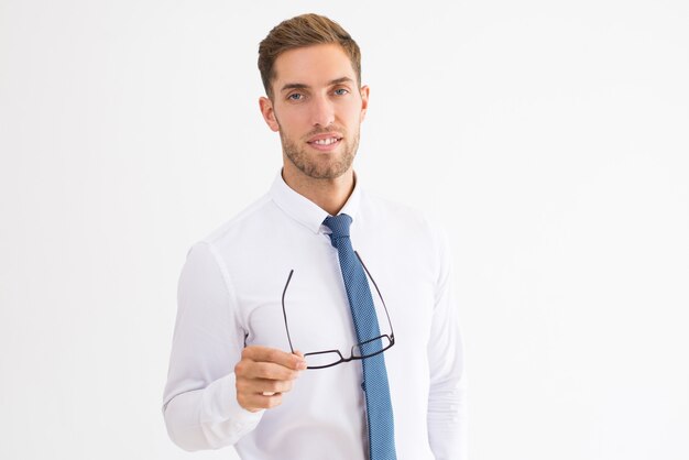 Relaxed business man holding glasses