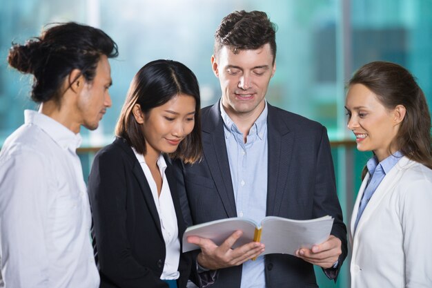 Relaxed Business People Reading Book Together