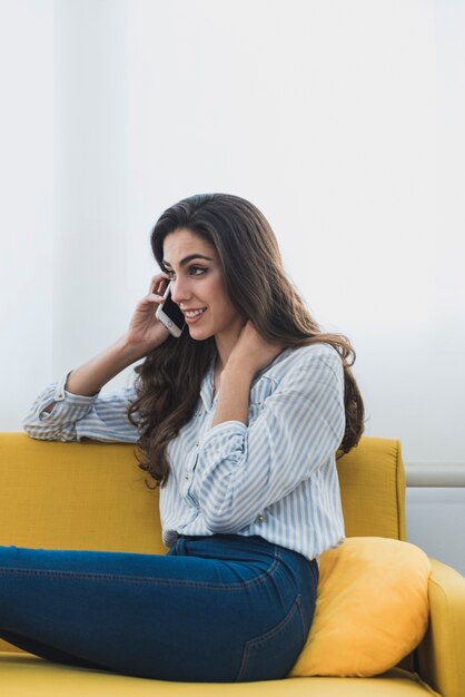 Relaxed businesswoman talking on the phone and touching her neck