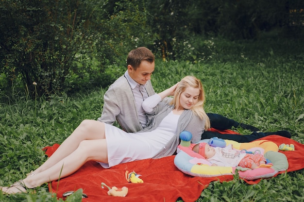 Relaxed couple with their baby in the park