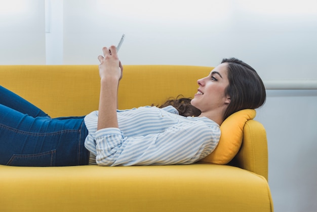 Free photo relaxed employee lying on the couch