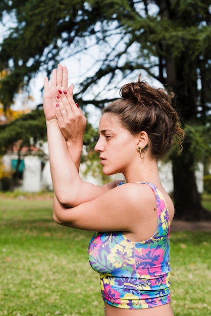 Free photo relaxed girl practicing yoga outdoor