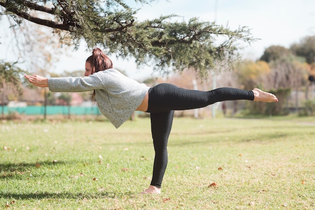 Relaxed girl practicing yoga outdoor