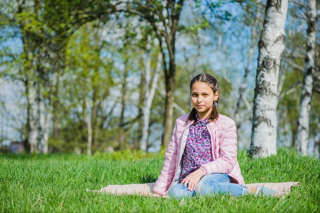 Relaxed girl sitting outdoors