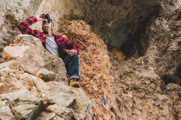 Relaxed hiker with binoculars