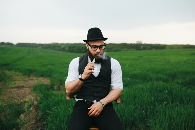 Relaxed man smoking outdoors