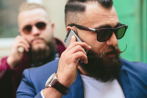 Relaxed man with glasses and smartphone