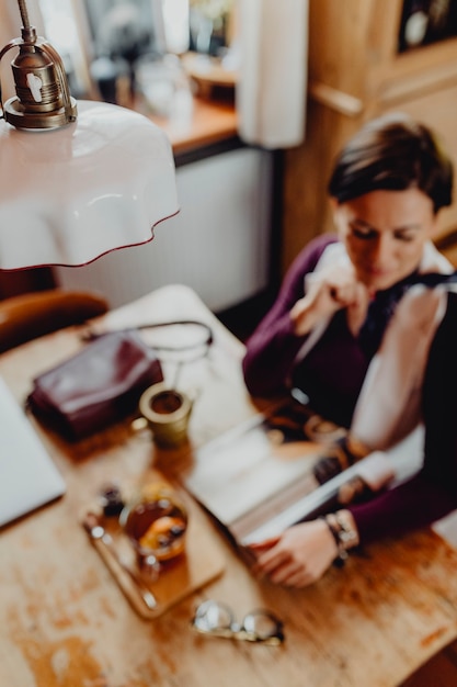 Relaxed woman enjoying a magazine at a cafe