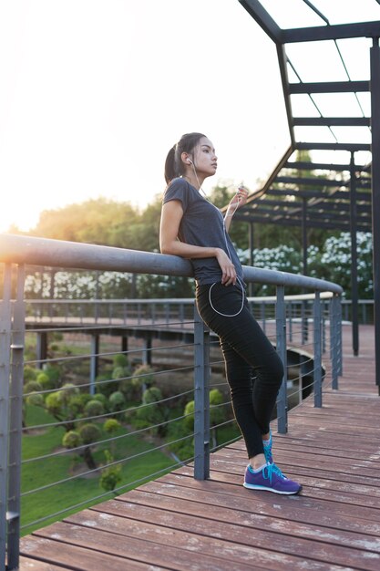 Relaxed woman listening to music after exercising