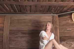 Free photo relaxed woman in sauna cuddling herself