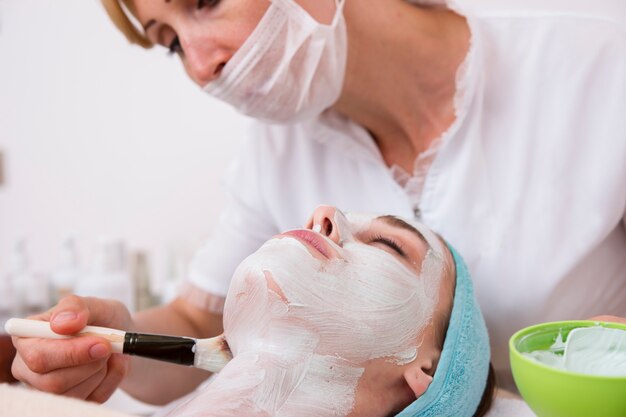 Relaxed woman taking care of her skin