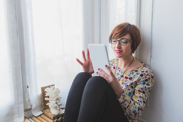 Relaxed woman using her tablet