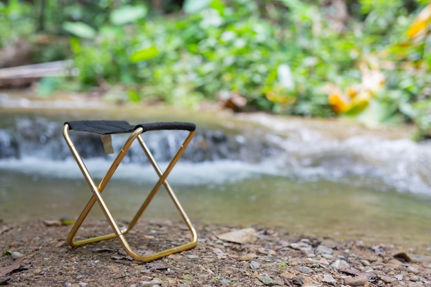 Relaxing chairs are placed by the river.