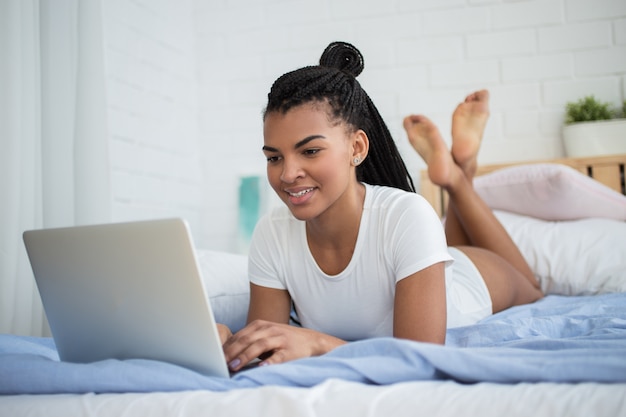 Relaxing female freelancer typing on laptop