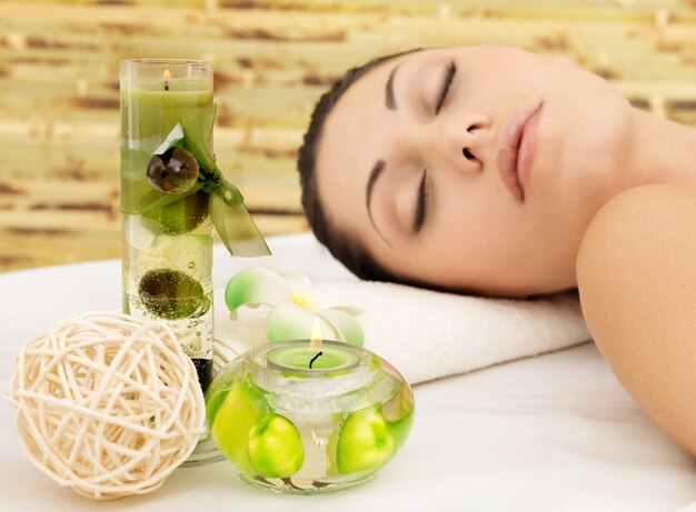 Relaxing white woman at beauty spa salon. Recreation therapy. Resting female with closed eyes