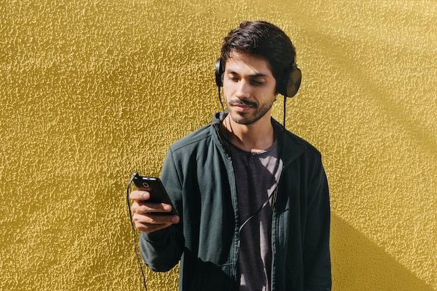 Relaxing young man using phone 