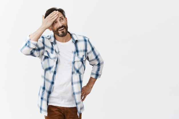 Relieved bearded mature man posing