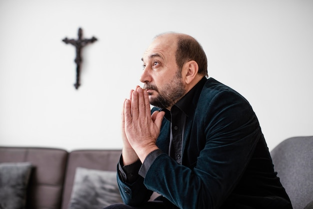 Free photo religious man praying indoors