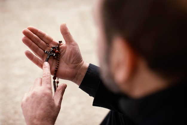 Religious man praying indoors