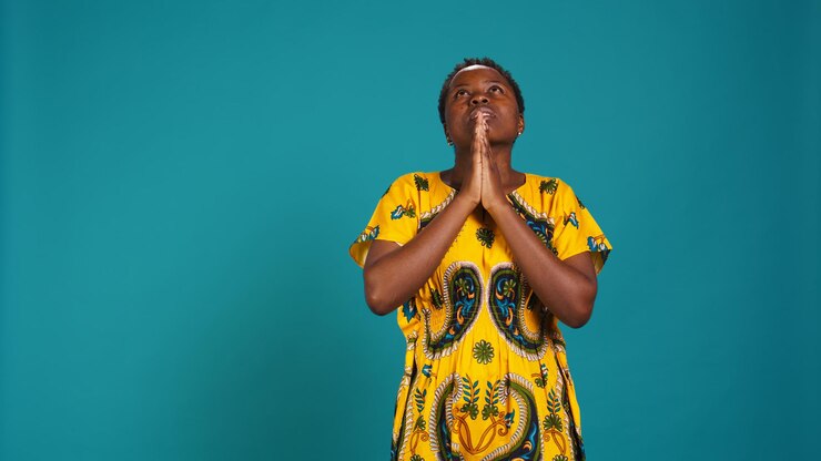 Free Photo religious optimistic girl praying to god for good fortune in studio