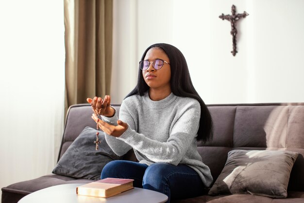 Religious woman holding rosary beads