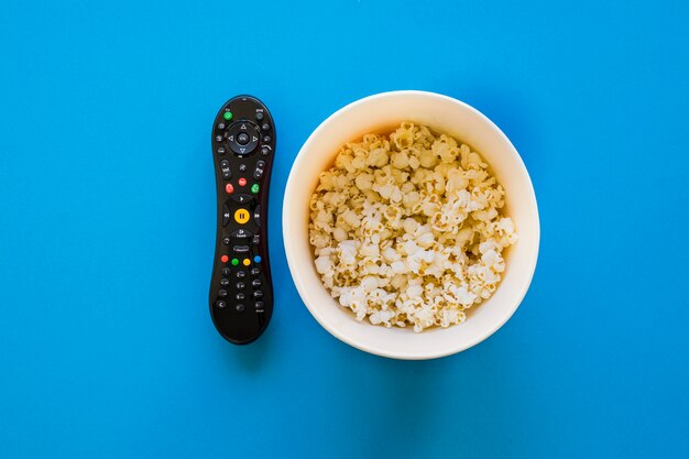 Remote control and bucket of popcorn