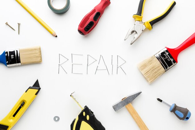 Repair word written with nails and repair utensils