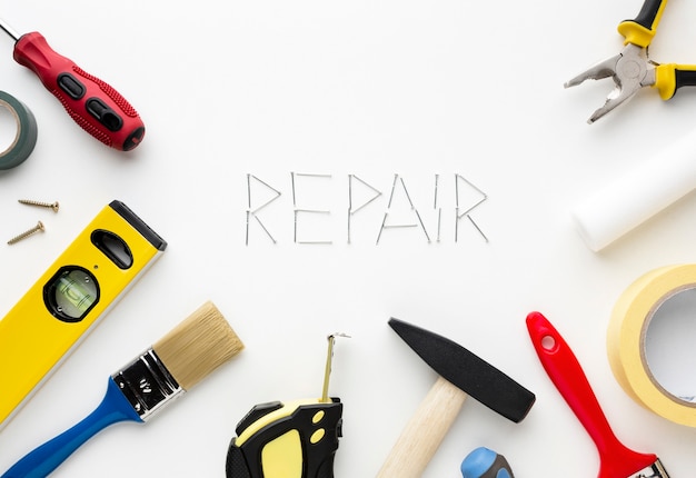 Repair word written with nails surrounded by tools