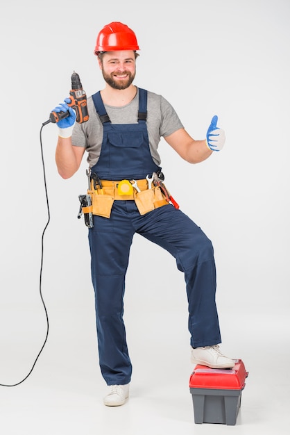 Repairman with drill showing thumb up