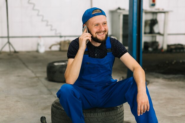 Repairmen talking on phone at workshop