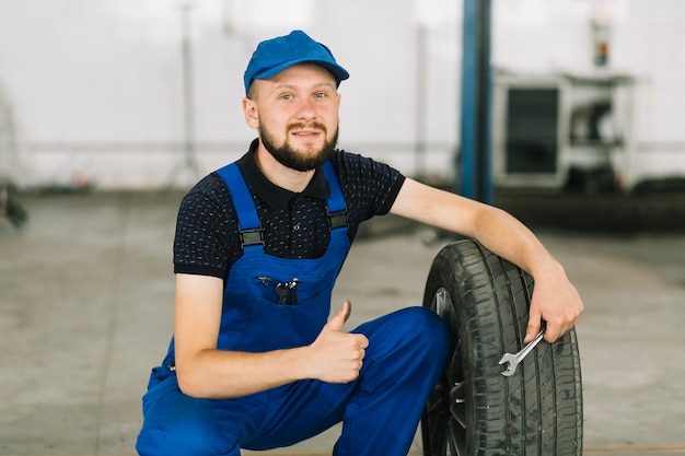 Repairmen and tire at garage