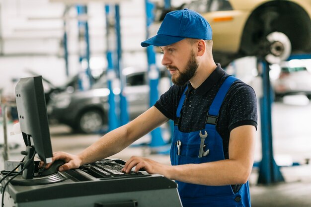 Repairmen using computer at workshop