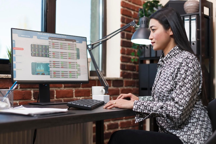 Free Photo research agency office worker analyzing organization financial data and statistics. young confident company employee reviewing startup project status charts while sitting in modern office.