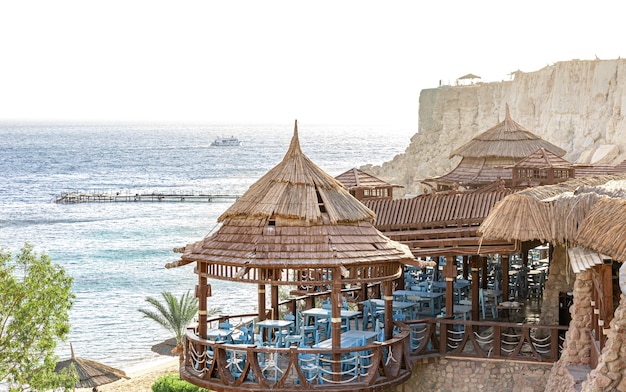 A restaurant complex on the seashore among the rocks.