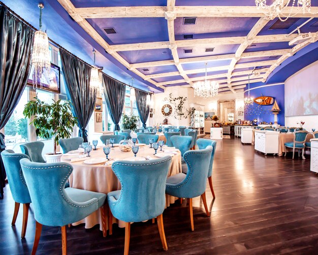 Restaurant hall with blue chairs and decors on the wall