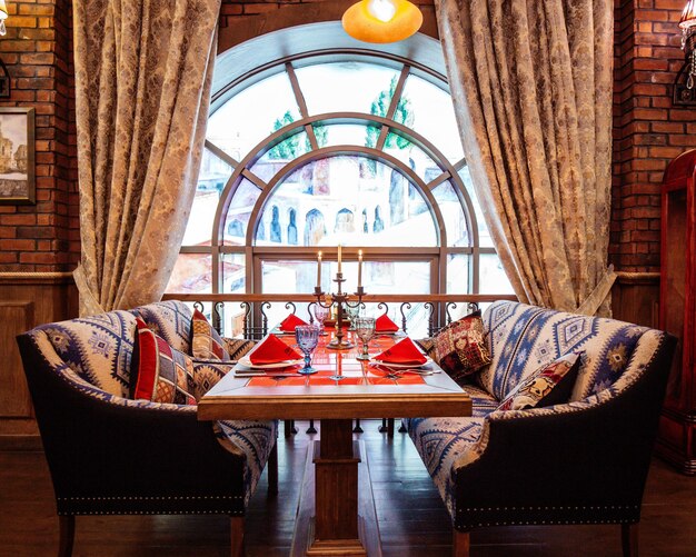 Restaurant table with two couches near the window