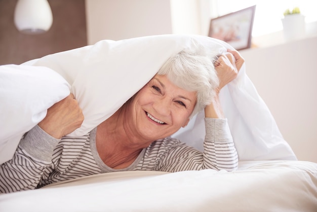 Free photo rested senior woman in her bedroom