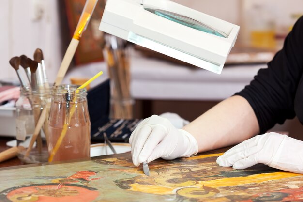 Restorer working on the ancient Christian icon