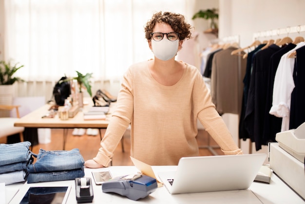 Retail shop owner in mask social distancing shopping