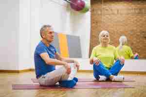 Free photo retired couple doing yoga