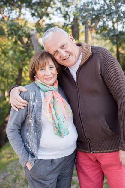 Retired couple hugging in nature