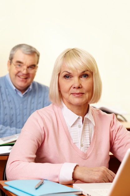 Retired couple studying with a computer