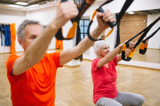 Retired couple training in fitness center